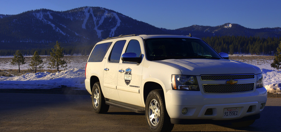 Tahoe Sierra Transportation private car service parked in front of a Lake Tahoe ski resort in California.